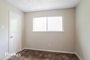 Katy house for rent - a bedroom with a window and a carpeted floor