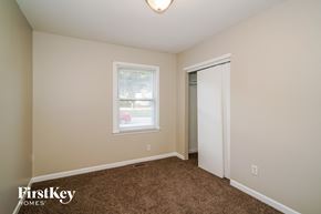 Indianapolis house for rent - a bedroom with carpet and a door to a closet