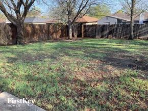 Watauga house for rent - A backyard with a fence and trees.