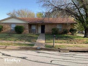 Watauga house for rent - A house with a brown roof and a driveway in front.