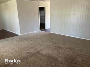 Watauga house for rent - A carpeted room with a doorway leading to another room.