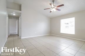 Orlando house for rent - A room with a ceiling fan and a window.