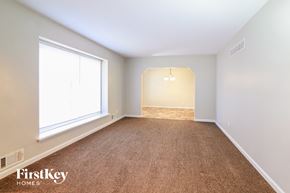 Grandview house for rent - a bedroom with a carpeted floor and a large window
