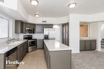 Glendale house for rent - a large kitchen with stainless steel appliances and white counter tops
