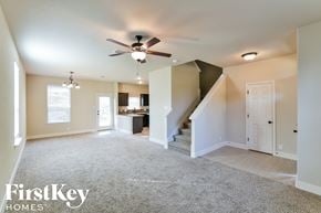 San Antonio house for rent - an empty living room with a ceiling fan and a kitchen