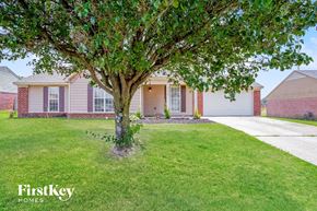 Horn Lake house for rent - A tree in front of a house with the words "FirstKey Homes" on the bottom.