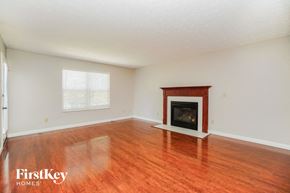 Westerville house for rent - a living room with a fireplace and wooden floors