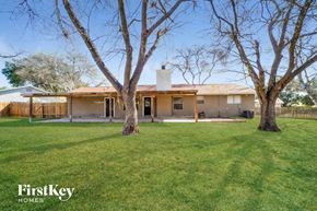 San Antonio house for rent - a backyard with two trees and a house
