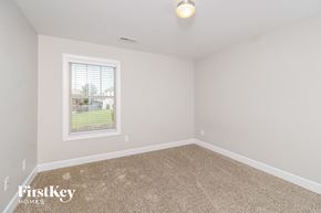 Whitsett house for rent - a spacious room with carpet and a window
