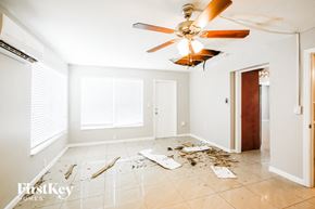 Hollywood house for rent - a room with construction debris on the floor and a ceiling fan