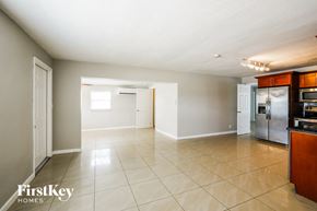 Hollywood house for rent - an empty kitchen and living room with stainless steel appliances and tiled floors