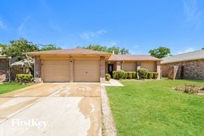Houston house for rent - A house with a brown garage door is for sale.