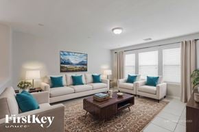 Spring house for rent - A virtual staged living room with a large painting, two couches, a coffee table, and a rug.