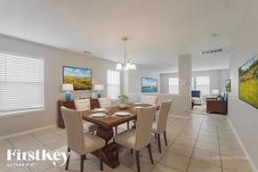 Spring house for rent - A dining room with a wooden table and chairs.
