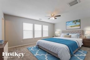 Spring house for rent - A bedroom with a large bed and a ceiling fan.