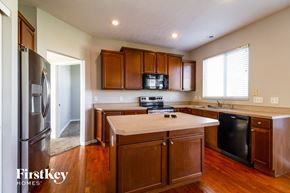 Morrow house for rent - a kitchen with wooden cabinets and stainless steel appliances