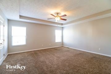 Morrow house for rent - a living room with carpet and a ceiling fan