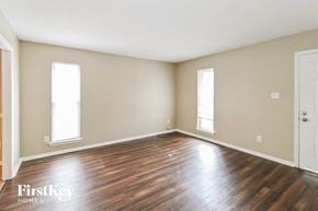 Memphis house for rent - the living room of an empty house with wood floors and a door