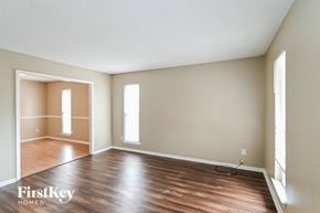 Memphis house for rent - an empty living room with wood floors and white walls