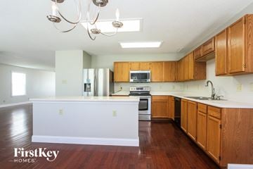 Indianapolis house for rent - A kitchen with wooden cabinets and a white island.