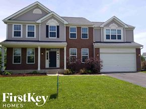 Mchenry house for rent - A house with a garage and a sign that says FirstKey Homes.