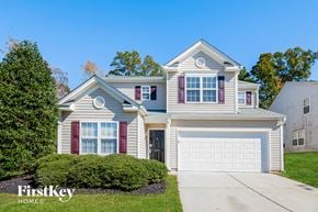 Charlotte house for rent - a home with a white garage door and a blue house