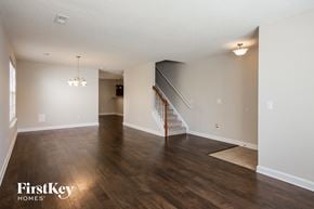 Charlotte house for rent - the living room and dining room with hardwood flooring and stairs to the upper