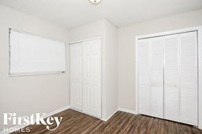 Hollywood house for rent - a bedroom with two closets and a window and wood flooring
