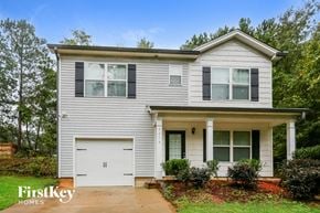 Gainesville house for rent - a white house with a white garage door