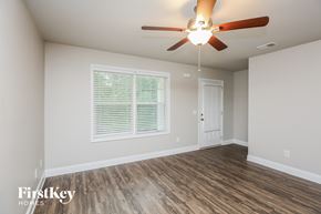 Gainesville house for rent - the living room of an empty house with a ceiling fan