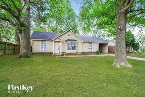 Memphis house for rent - the front of a house with two trees