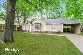 Memphis house for rent - a white house with a yard and a tree