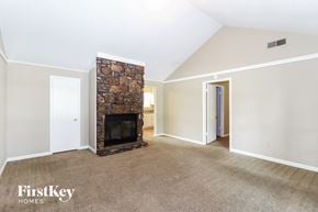 Memphis house for rent - a living room with a fireplace and a carpeted floor