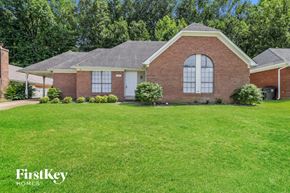 Memphis house for rent - a brick house with a lawn in front of it