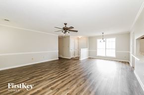 Memphis house for rent - an empty living room with a ceiling fan and wood floors