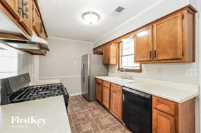 Memphis house for rent - a kitchen with a stove refrigerator and sink