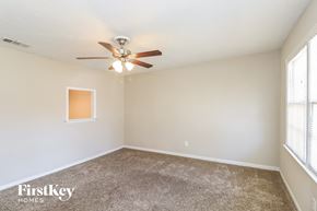 Lithia Springs house for rent - A room with a ceiling fan and a window.