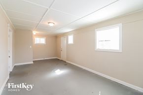 Lithia Springs house for rent - A spacious empty room with a window and a door.