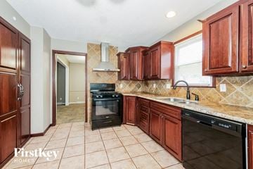 Grandview house for rent - A kitchen with wooden cabinets and a tile floor.