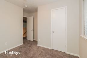 Katy house for rent - a bedroom with two closets and a carpeted floor