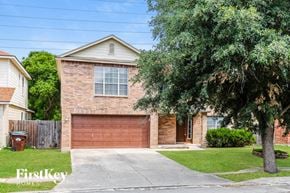 Converse house for rent - a brick house with a garage door and a tree