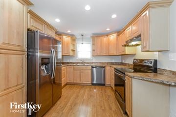 Parkville house for rent - a kitchen with wooden cabinets and stainless steel appliances