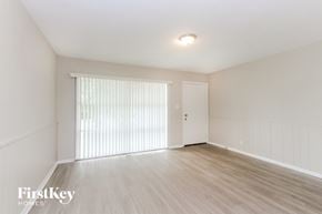 Indianapolis house for rent - A room with wooden flooring and a sliding door.