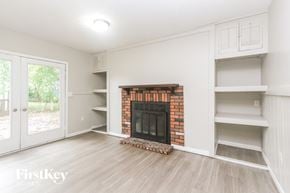 Indianapolis house for rent - A living room with a fireplace and built-in shelves.