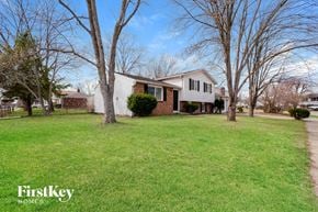 Indianapolis house for rent - A house with a lawn and trees in front of it.
