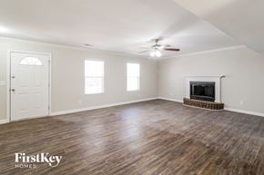 North Charleston house for rent - the living room with wood flooring and a fireplace