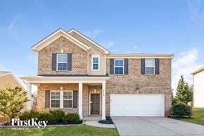 Charlotte house for rent - a brick house with a white garage door