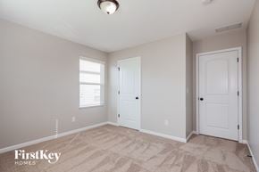 Charlotte house for rent - a bedroom with two doors and a carpeted floor