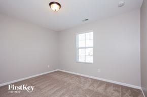 Charlotte house for rent - the living room of a new home with white walls and a window