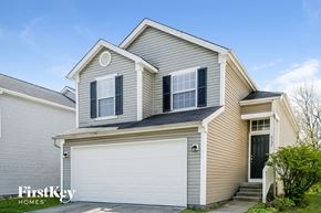 Indianapolis house for rent - a yellow house with a white garage door